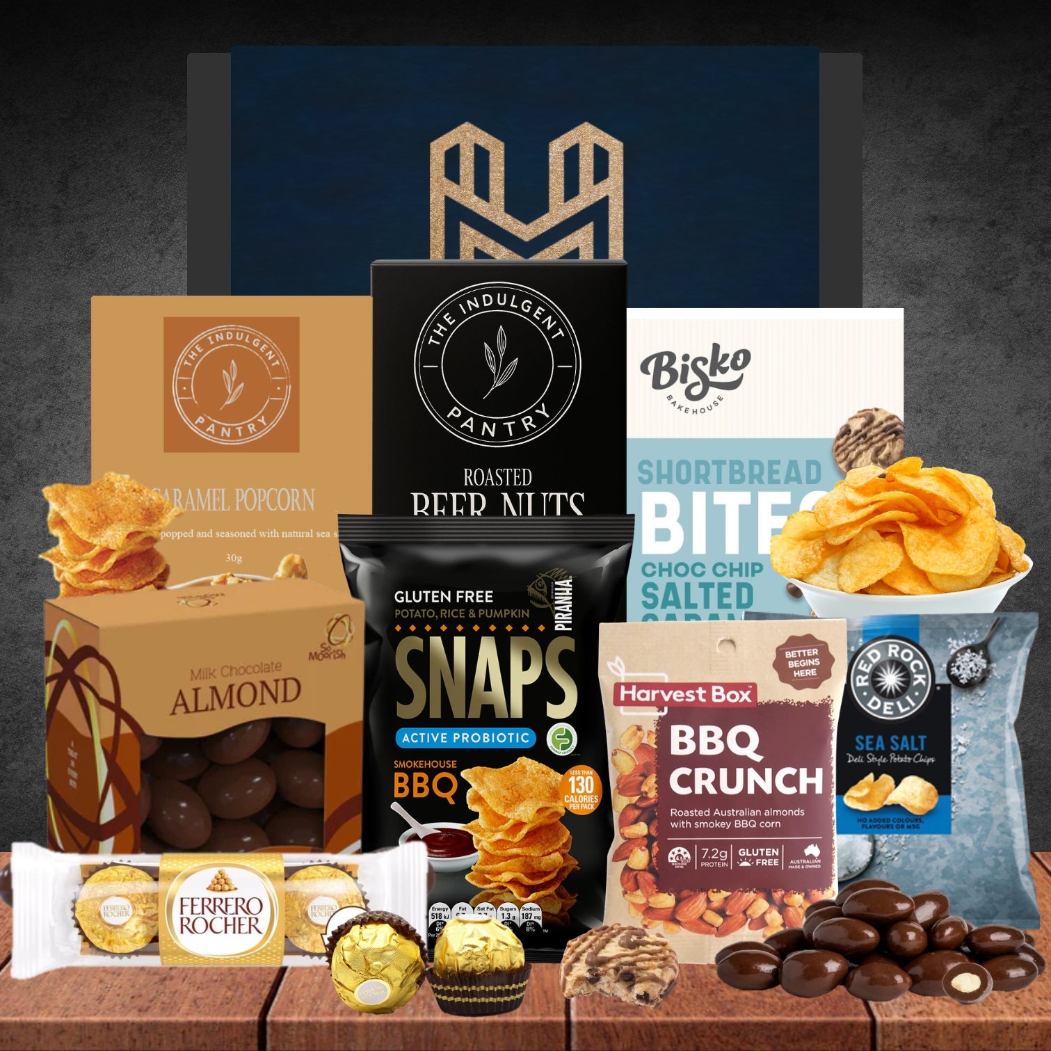 Assorted snacks and treats from various brands on a wooden surface with a dark background.