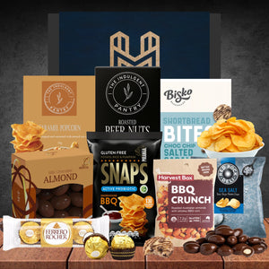 Assorted snacks and treats from various brands on a wooden surface with a dark background.