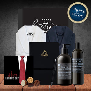 Father's Day gift set with robes, ties, and personal care products on a wooden surface.