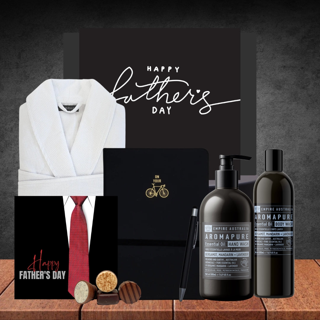 Father's Day gift set with robe, tie, cards, and toiletries on a wooden surface.