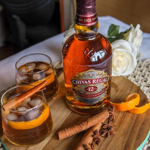 Chivas Regal 12 Year Old Blended Scotch Whisky bottle with glasses